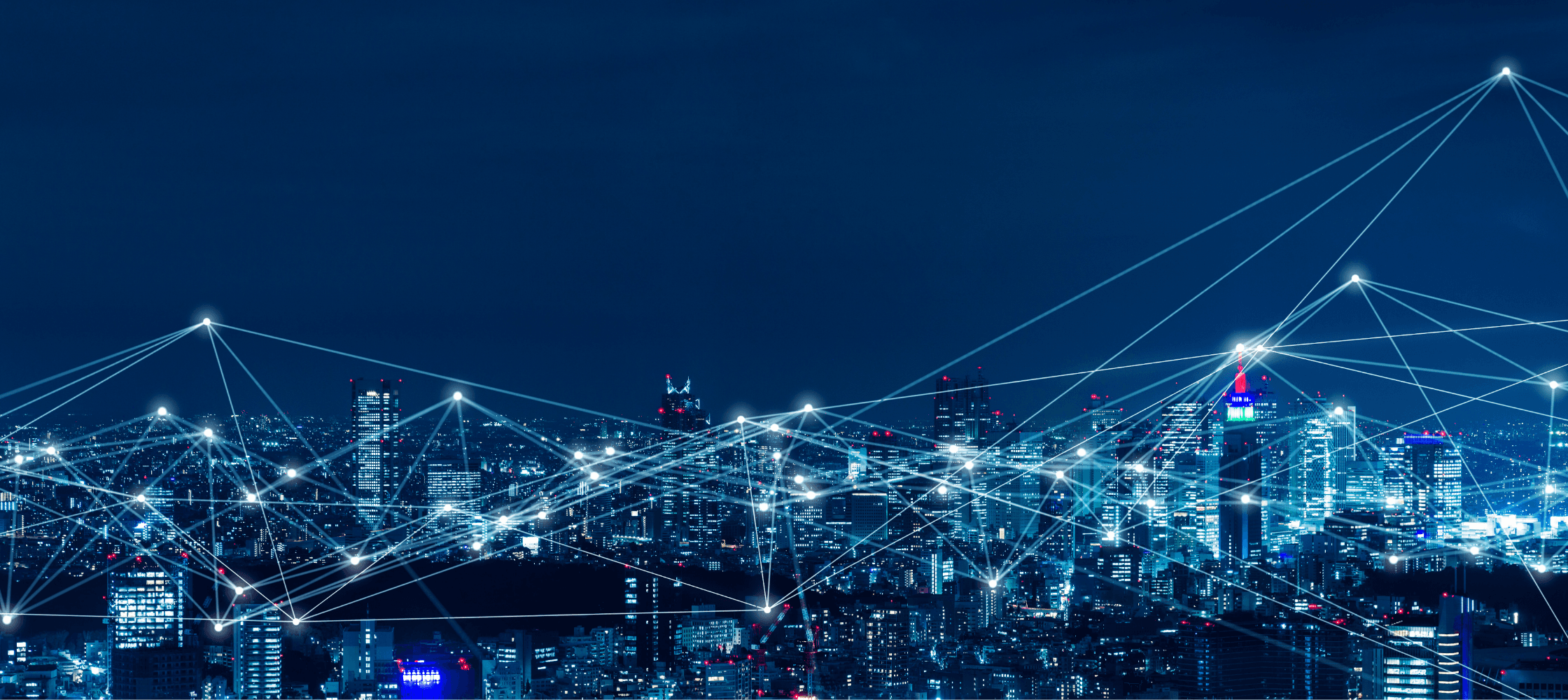 Illuminated city skyline at night representing AI-powered consulting at enterprise scale