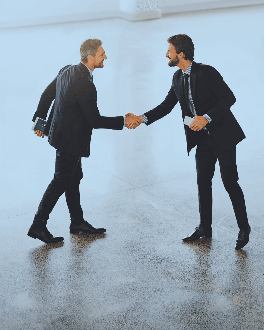 Two men shaking hands demonstrating collaboration